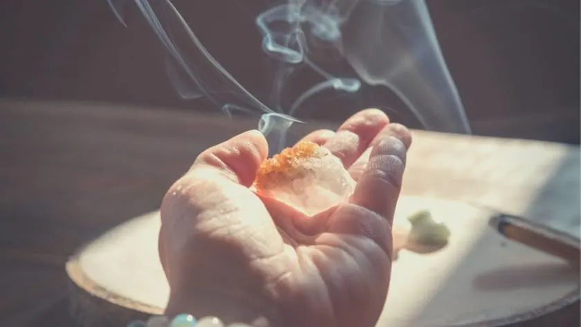 Image of someone utilizing citrine crystals to attract money