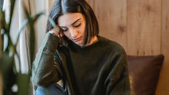 Image of a woman feeling drained as a sign of a negative energy in the home